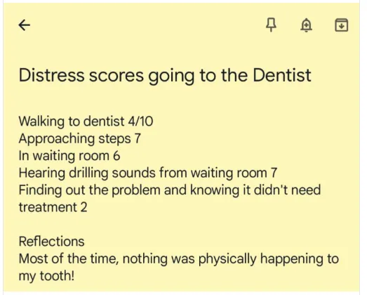 Person looking anxious in dental waiting room with a notepad tracking anxiety levels