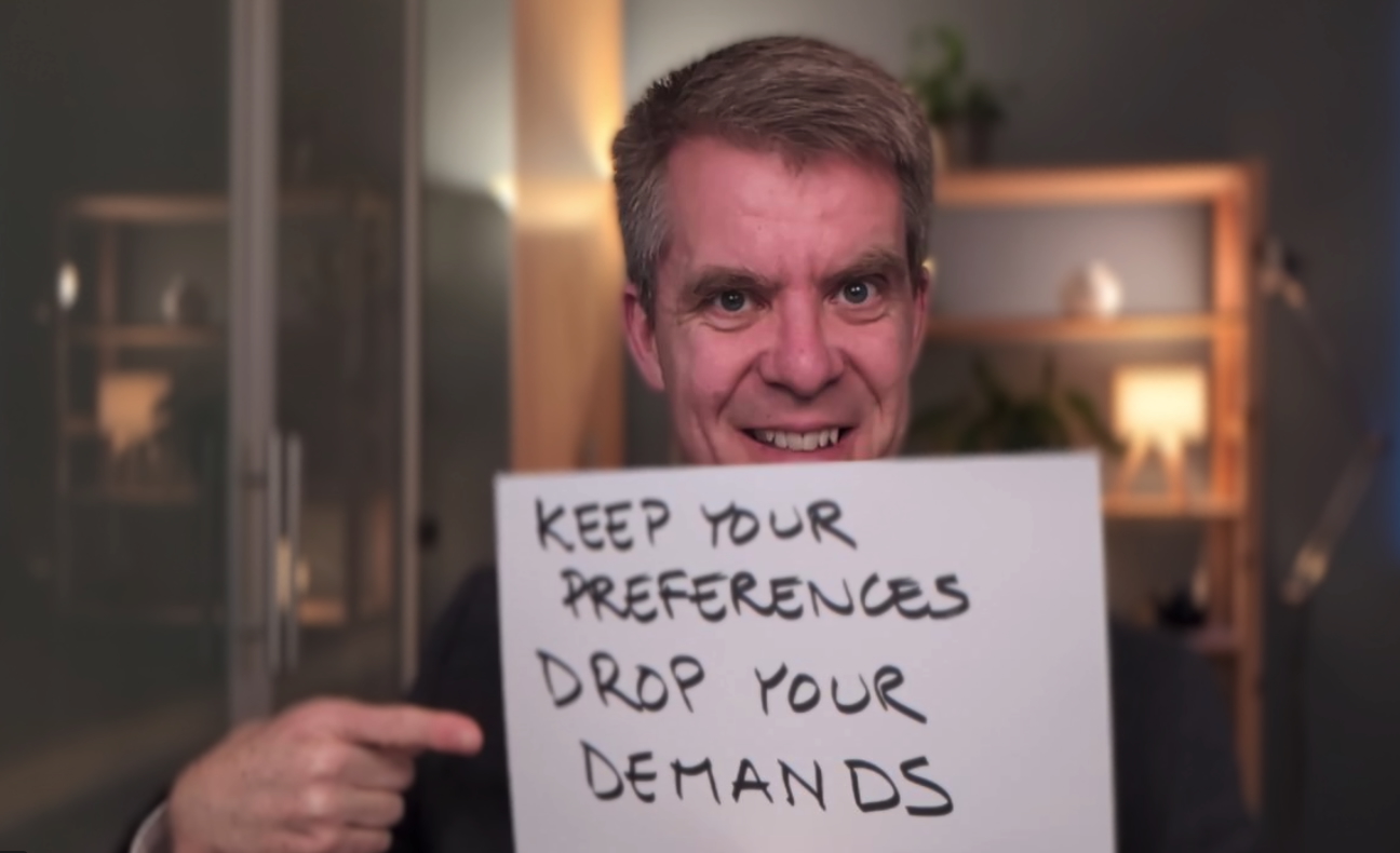 Benjamin holding up a sign saying keep your preferences drop your demands